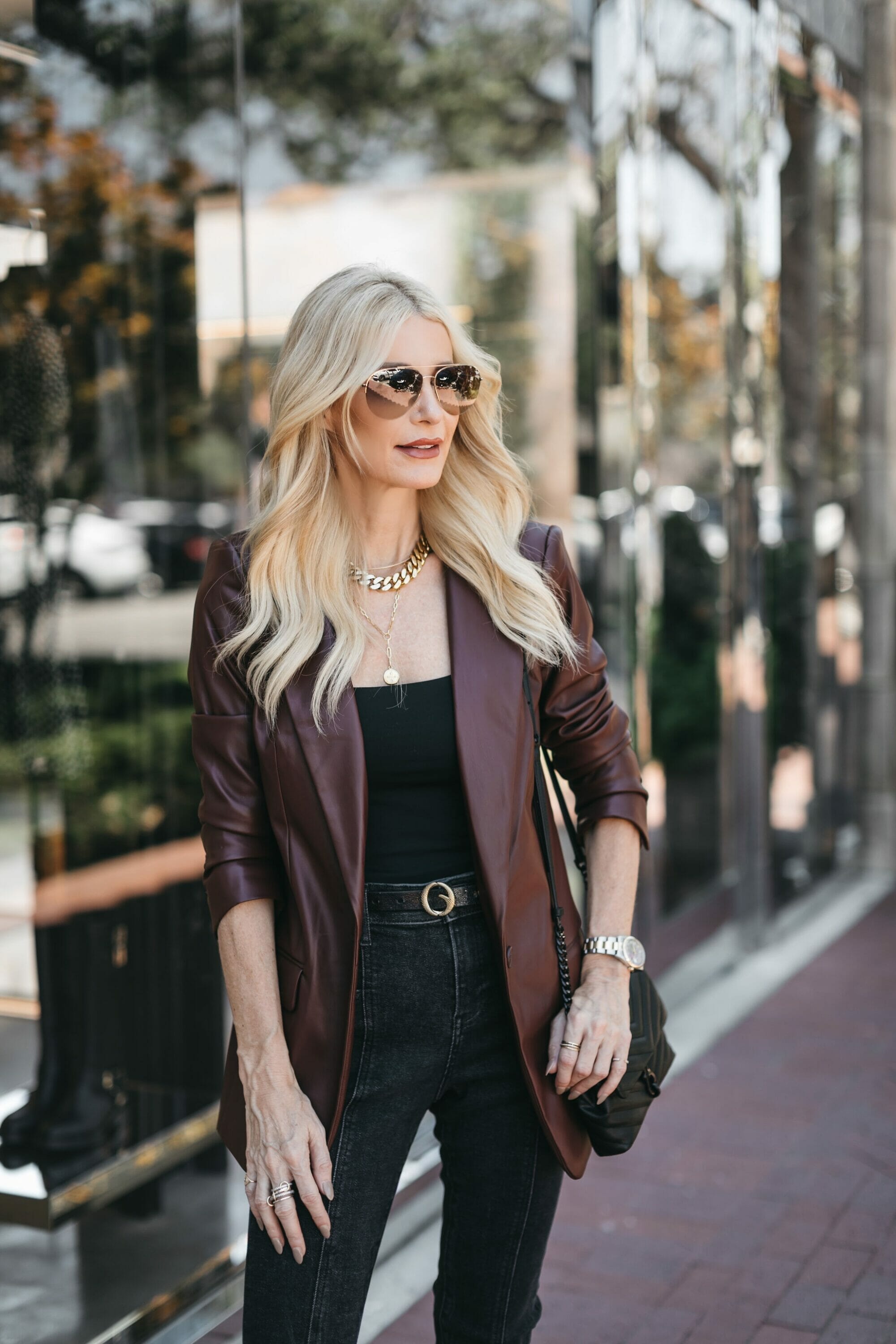 Over 40 fashion stylist from Dallas wearing a brown leather blazer with black faded jeans as one of 7 chic looks from Express