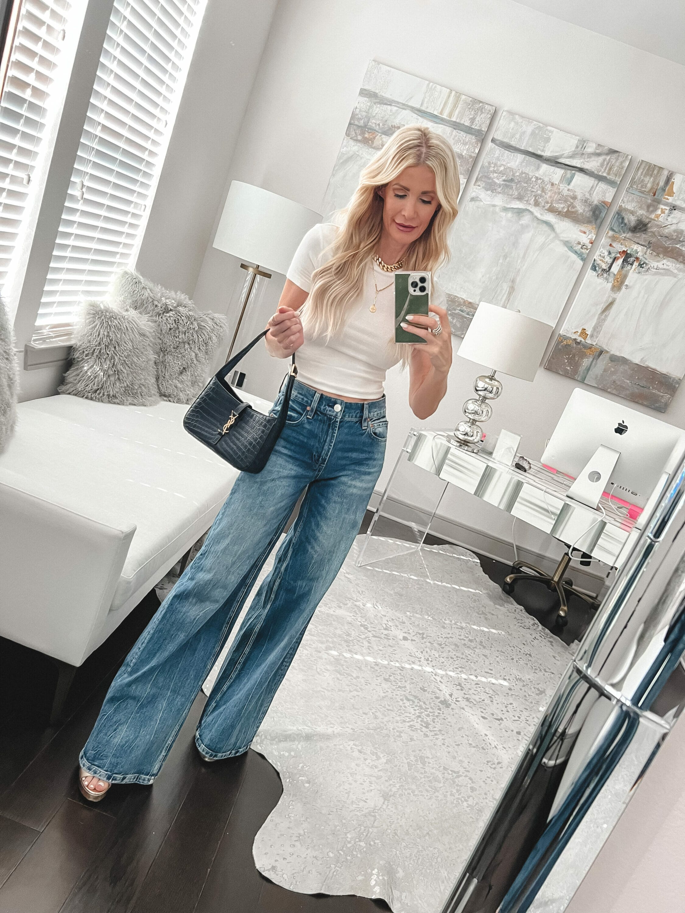 Over 40 fashion blogger wearing white tee with baggy jeans.