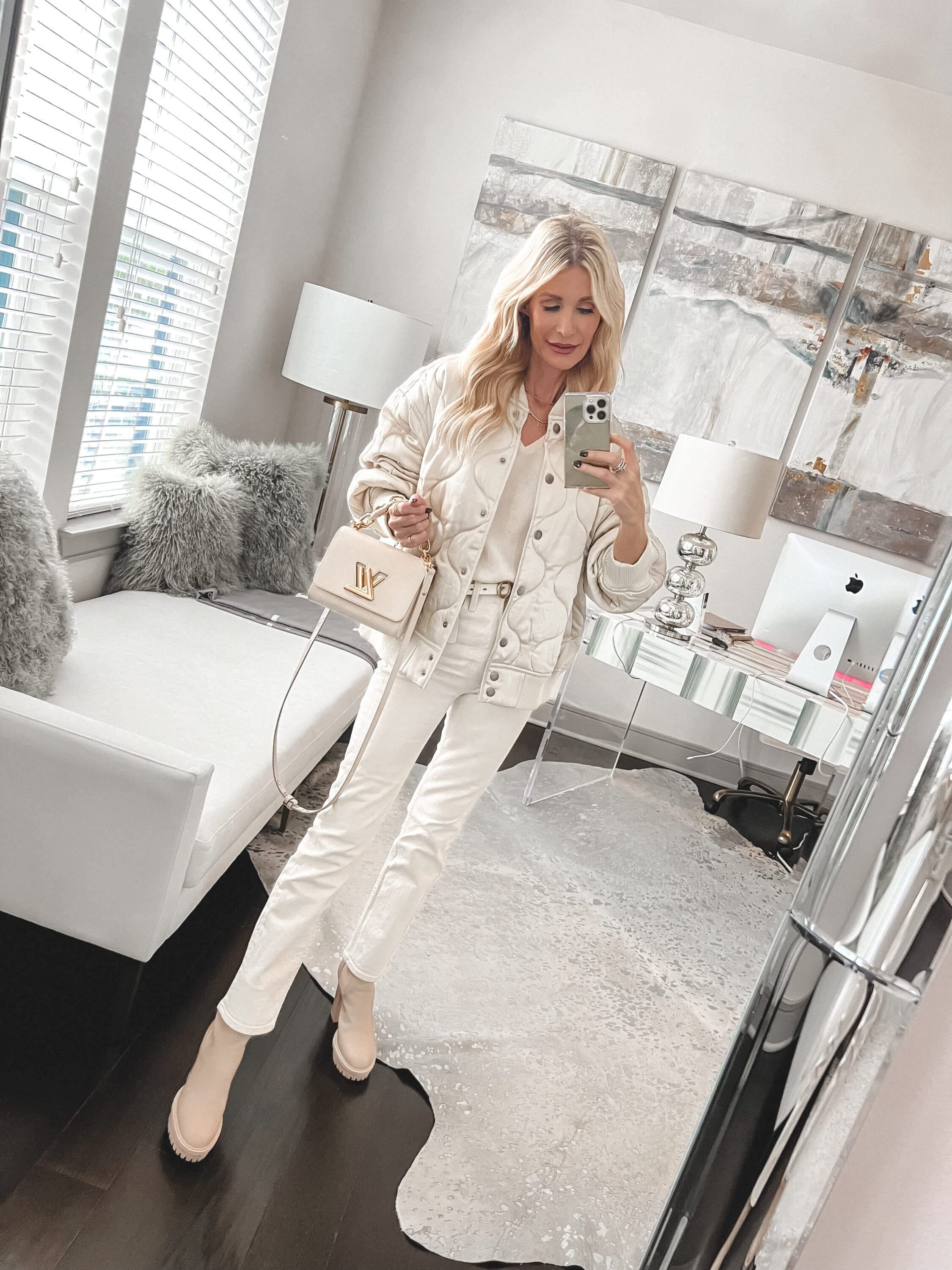 Over 40 fashion blogger wearing quilted white jacket, white bodysuit and ivory jeans as one of 5 chic thanksgiving outfits.