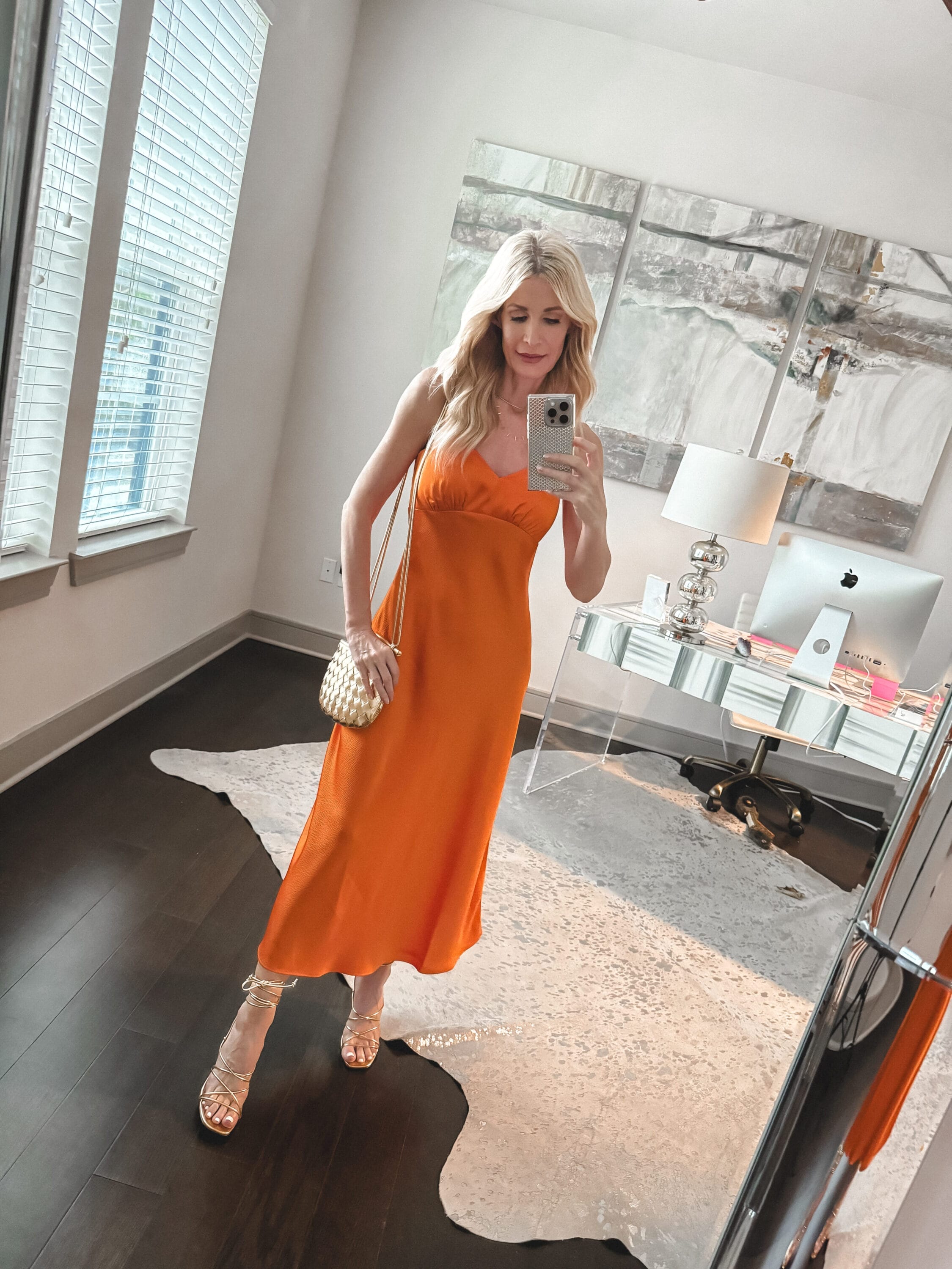 Dallas fashion blogger for women over 40 wearing an orange slip dress as an example of under $50 spring wardrobe essentials.